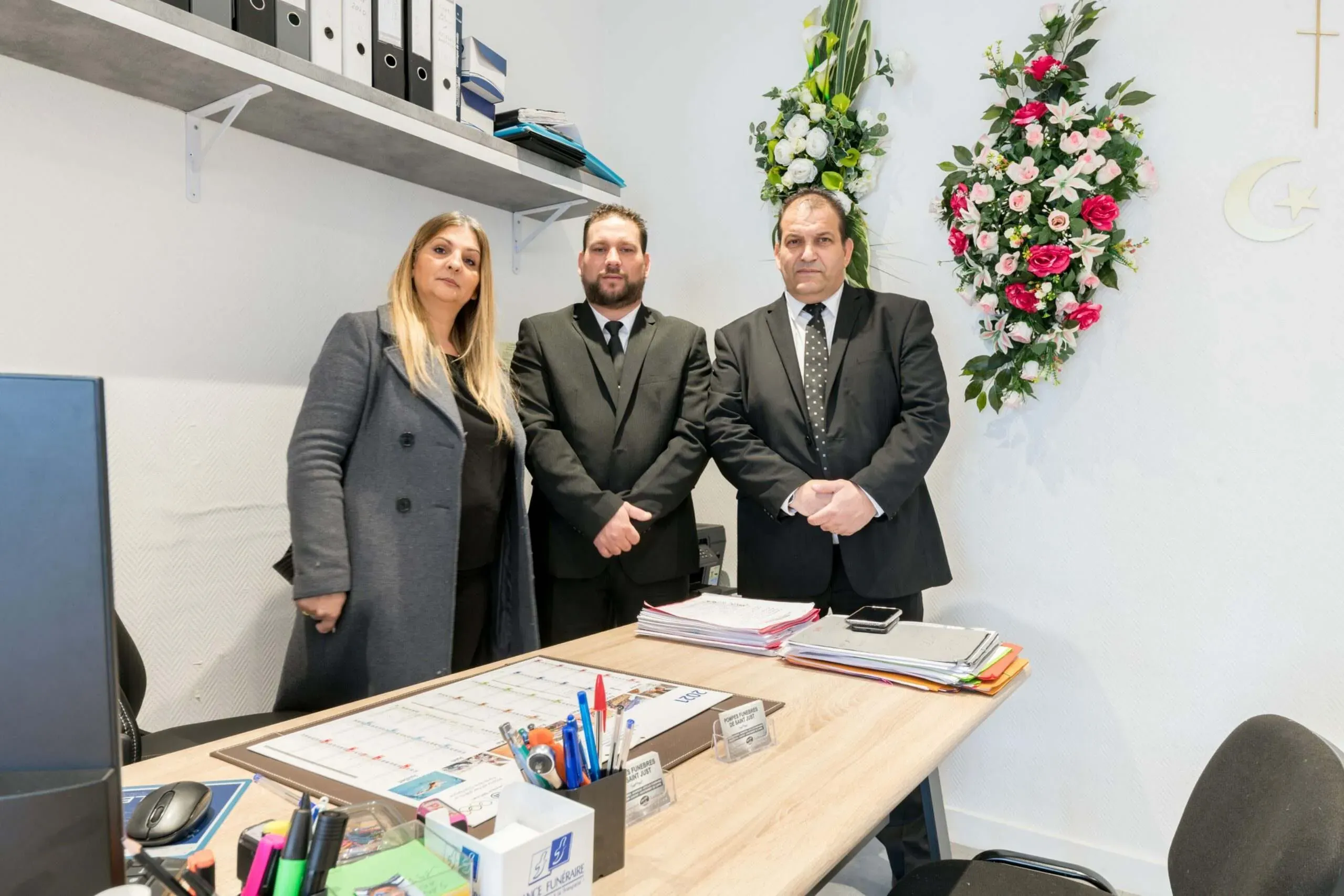 Équipe des Pompes Funèbres de Saint Just debout dans un bureau d'accueil administratif
